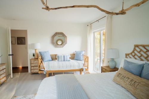 a bedroom with a bed with blue and white pillows at Boho chic oasis by Casa Oso with pool, spa and views in Ahwahnee