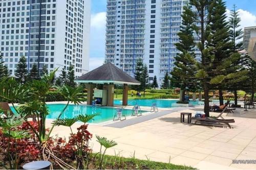a swimming pool with a gazebo and some buildings at Sevilla's Place in Tagaytay