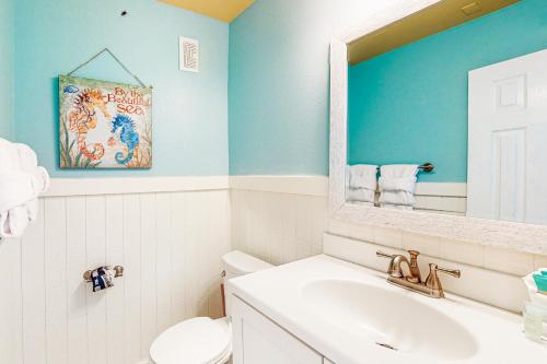 a bathroom with a toilet and a sink and a mirror at Peace of Paradise in Navarre