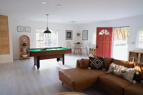 a living room with a couch and a pool table at Boho chic oasis by Casa Oso with pool, spa and views in Ahwahnee