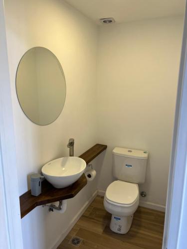 a bathroom with a sink and a toilet and a mirror at Loft .Once de Abril in Bahía Blanca