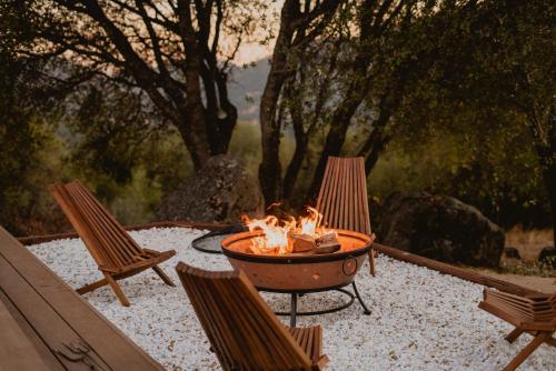 a fire pit on a patio with two chairs at Boho chic oasis by Casa Oso with pool, spa and views in Ahwahnee