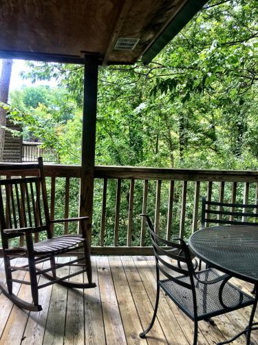 a patio with two chairs and a table on a deck at C13 - Forest View two bedroom, two bath Harbor North luxury loft cottage with private hot tub o Lake on Ouachita in Mount Ida