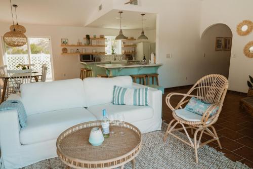 a living room with a white couch and a table at Boho chic oasis by Casa Oso with pool, spa and views in Ahwahnee