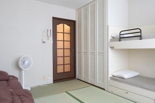 a room with a door leading to a bunk bed at Angel Resort Yuzawa / Vacation STAY 7045 in Yuzawa