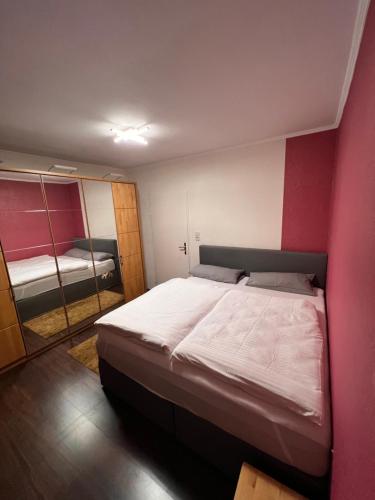 a bedroom with a large bed and a mirror at OTTO Apartment Bremen in Bremen