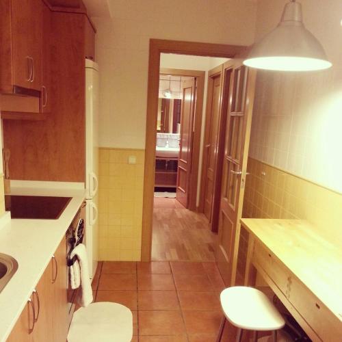 a kitchen with two chairs and a sink in it at Apartamento Bielsa-Monte Pérdido in Bielsa