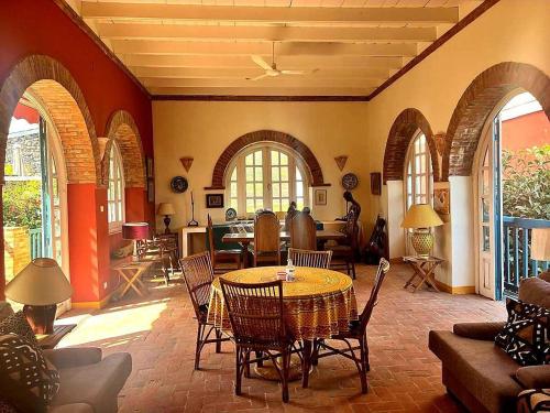 a living room with a table and chairs at Principauté in Gorée