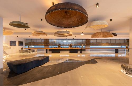 a large lobby with a large couch and umbrellas at Travelodge Nimman in Chiang Mai