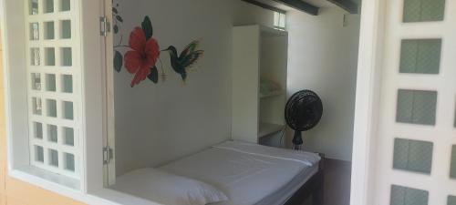 a white cabinet with a bed in a room at Casa Ceiba Mar cerca a Volcán in Arboletes
