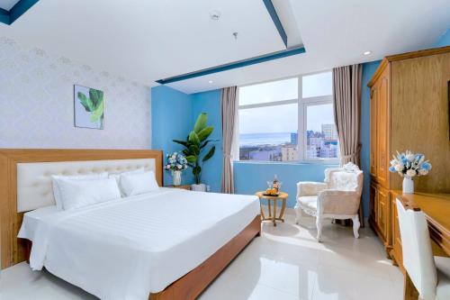 a hotel room with a bed and a window at Royal Family Hotel in Da Nang