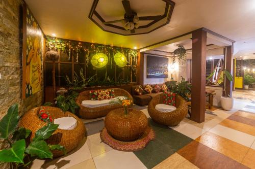a lobby with wicker chairs and a living room at Natura Vista in Panglao