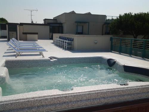 a swimming pool on the roof of a house at Affittacamere FloraMare in Marina di Bibbona