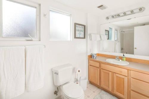 a bathroom with a toilet and a sink and a mirror at Beautiful home, Central location, Close to Beach in Seattle