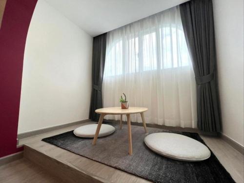 a room with a table and a window at Hotel Midtown Ratsada in Phuket Town
