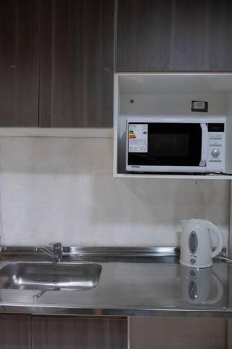 a microwave above a sink in a kitchen at Refugio de Piedras in Ciudad Lujan de Cuyo