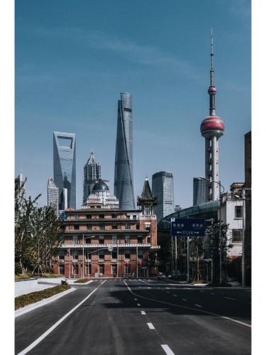 an empty street in a city with tall buildings at Dayin Youth Hostel - East Nanjing Road & People's Square & The Bund -Large Social Area -Bar -Café -Gym -Free Laundry Luggage Storage -24H Front Desk -English Service in Shanghai
