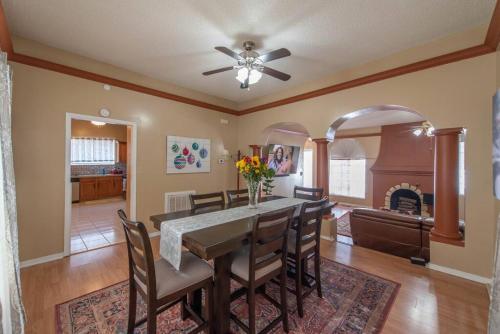 a dining room with a table and chairs and a fireplace at A Spanish Castle For Your Living Pleasure in Little Rock