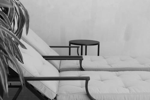 a white couch and a table in a room at Casa Nova Centro Oaxaca - Adults Only in Oaxaca City