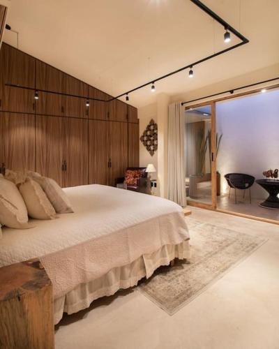 a bedroom with a large bed and a large window at Casa Nova Centro Oaxaca - Adults Only in Oaxaca City
