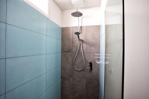 a shower in a bathroom with blue tiles at BELLA CASA in Queenscliff