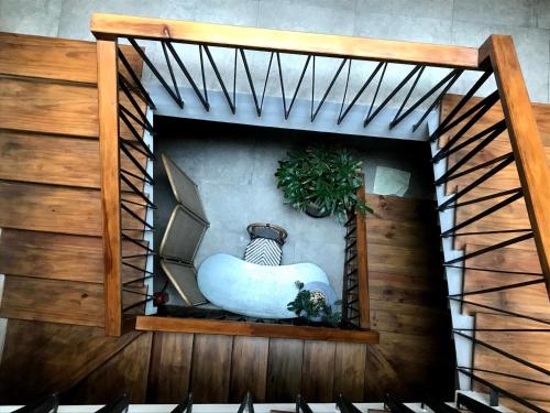 a spiral staircase with a white tub in a room at Green River Boutique Hotel in Vung Tau