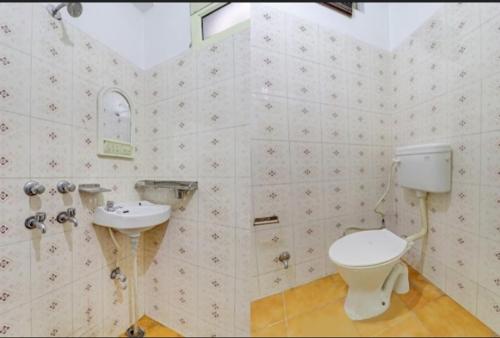 a bathroom with a toilet and a sink at HOTEL GANGA VIEW harry stay in Shivpuri