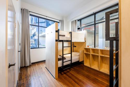 a room with bunk beds and a large window at Bunk Brisbane in Brisbane