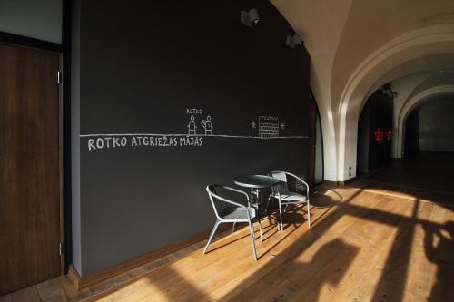 a room with two chairs and a table at Rothko Museum residences in Daugavpils