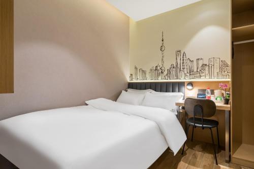 a hotel room with two beds and a desk at Meego Smart Select Hotel in Shanghai
