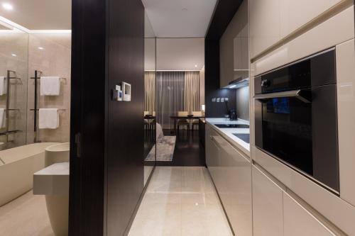 a large kitchen with a sink and a microwave at Bukit Bintang Signatures by Premium Hospitality in Kuala Lumpur