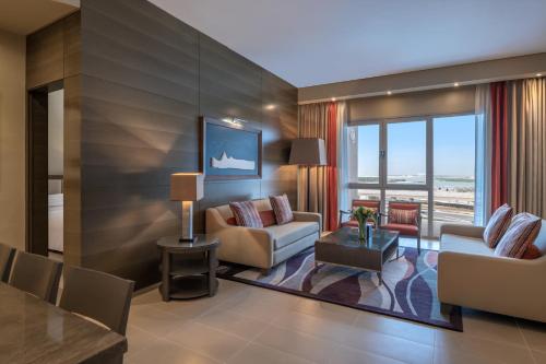 a living room with a couch and a table at Park Arjaan by Rotana, Abu Dhabi in Abu Dhabi