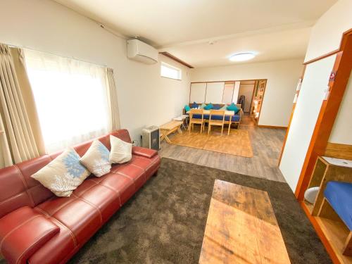 a living room with a couch and a dining room at Port Front ポートフロント in Shiraoi