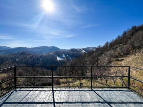 a balcony with a view of the mountains at Cabana A-Frame Refugiu Montan in Băişoara