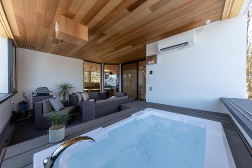 a swimming pool in the middle of a house at Le Sauna Villa Hakuba by JAMSZ ROYALE in Hakuba