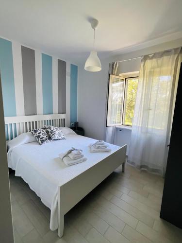 a bedroom with a bed with blue and white stripes at Edoardo e Franca in Minturno