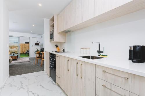 a kitchen with a sink and a counter top at 1 bed Central City Deluxe w/carpark in Christchurch