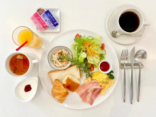 a white plate with breakfast food on a table at Wright Style in Naoshima