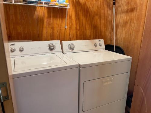 two washing machines sitting next to each other in a room at Cox Cabin On The River in Red River