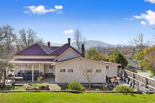 a white house with a porch and a yard at Healesville Garden Grandview in Healesville