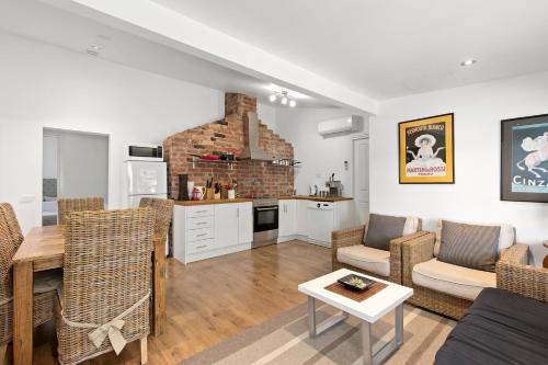 a living room with a table and chairs and a kitchen at Healesville Garden Grandview in Healesville