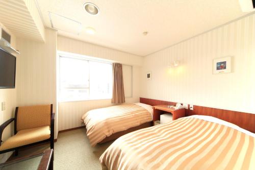 Postel nebo postele na pokoji v ubytování Nagano Daiichi Hotel