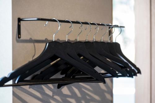 a row of black shirts hanging on a rack at nabe cape in Tagawa