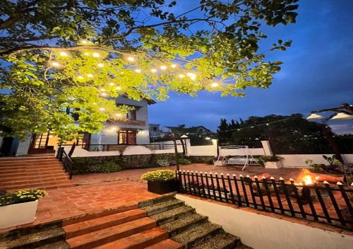 a house with a string of lights on a patio at NHỚ House V in Da Lat