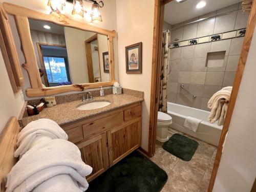 a bathroom with a sink and a toilet and a tub at 141 Premium Condo in Mammoth Lakes