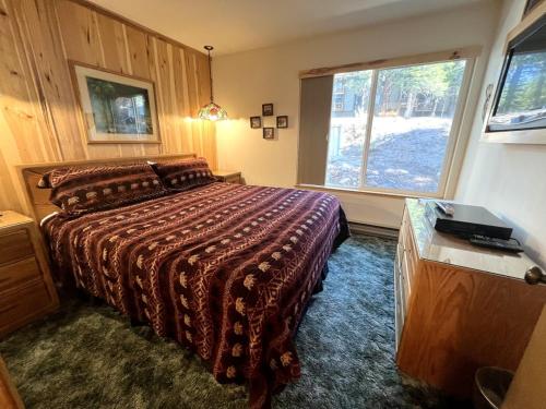 a bedroom with a bed and a large window at 141 Premium Condo in Mammoth Lakes