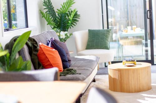 a living room with a couch and two chairs at Gateway to Hagley park - 2 bed w/carpark in Christchurch