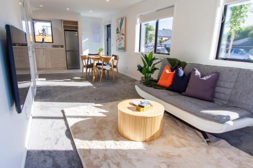 a living room with a couch and a table at Gateway to Hagley park - 2 bed w/carpark in Christchurch