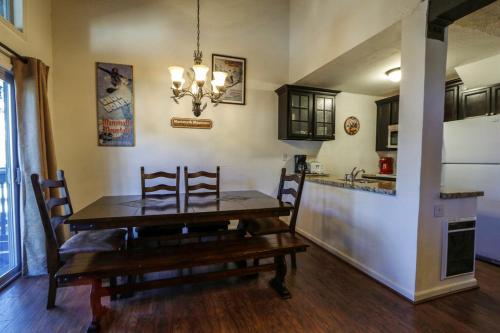 a dining room with a table and a kitchen at Chamonix Condo 94 Condo in Mammoth Lakes