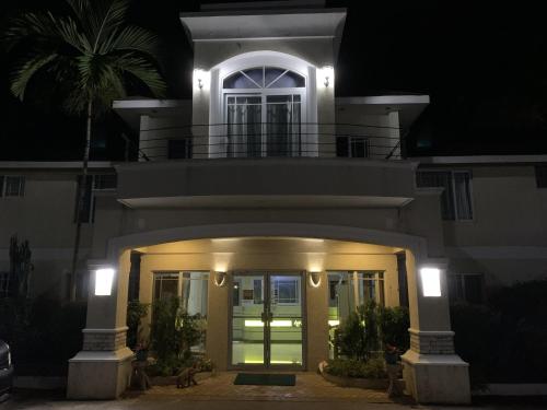 a large house with an entry way at night at Family Comfort in Jamaica - Enjoy 7 miles of White Sand Beach! villa in Negril